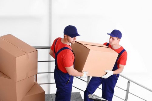 Professional movers managing stairs and access in a Hounslow apartment